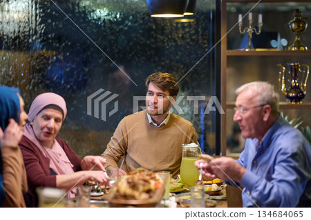 Family enjoys iftar in a restaurant with Ramadan decorations during the holy month Family enjoys iftar in a restaurant with Ramadan decorations during the holy month 134684065