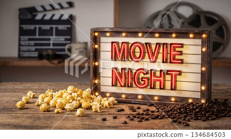 Movie night setup with snacks on a wooden table in a cozy room during evening hours 134684503