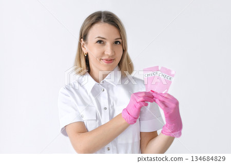A female doctor shows packages of rapid pregnancy and ovulation tests 134684829