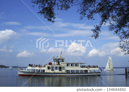 Steamboat with tourists at Chiemsee, Chiemgau, Bavaria, Germany Steamboat with tourists at Chiemsee, Chiemgau, Bavaria, Germany 134684892
