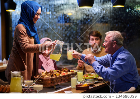 Muslim family sharing iftar in a restaurant with Ramadan decorations and warm lighting Muslim family sharing iftar in a restaurant with Ramadan decorations and warm lighting 134686359