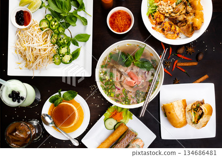 Overhead Flat Lay of Vietnamese Pho and Assorted Dishes 134686481
