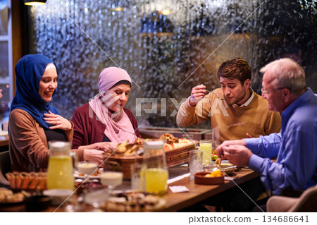 Muslim family enjoys iftar together in a restaurant with Ramadan decorations during the holy month 134686641