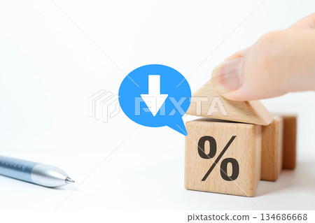 Building block house and percent symbol showing falling interest rates. Mortgage loan concept. 134686668
