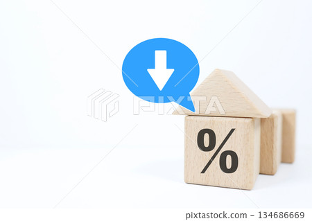 Building block house and percent symbol showing falling interest rates. Mortgage loan concept. 134686669