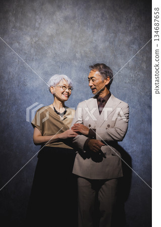 Smiling senior couple with arms crossed 134687658