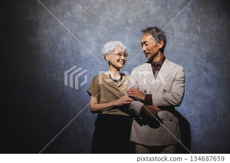Smiling senior couple with arms crossed 134687659
