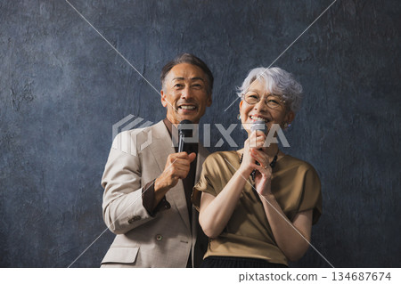 Smiling senior couple with arms crossed 134687674
