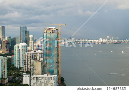 New construction site in Miami, Florida. Developing residence in American urban area. Concept of housing growth in the USA New construction site in Miami, Florida. Developing residence in American urban area. Concept of housing growth in the USA 134687885