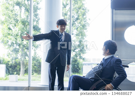 A man in a suit sitting in a wheelchair A man in a suit sitting in a wheelchair 134688027