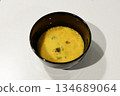Bowl of beaten eggs, top view, white background 134689064