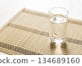 A glass of water placed on a Japanese-style mat 134689160