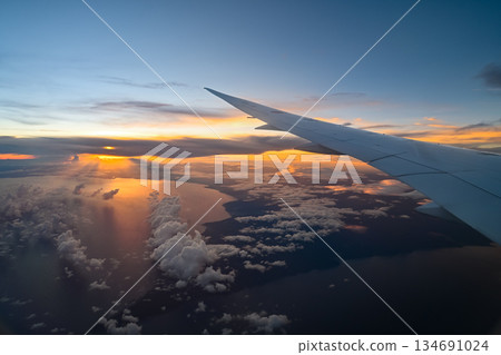 Beautiful sunset landscape photograph taken from inside an airplane Beautiful sunset landscape photograph taken from inside an airplane 134691024