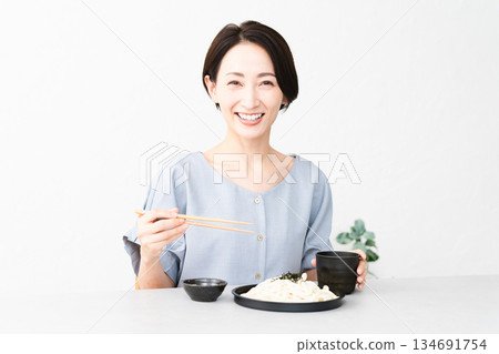 Woman eating udon noodles lifestyle image Woman eating udon noodles lifestyle image 134691754