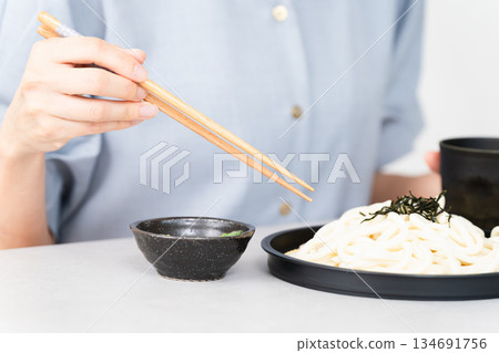 Woman eating udon noodles lifestyle image Woman eating udon noodles lifestyle image 134691756