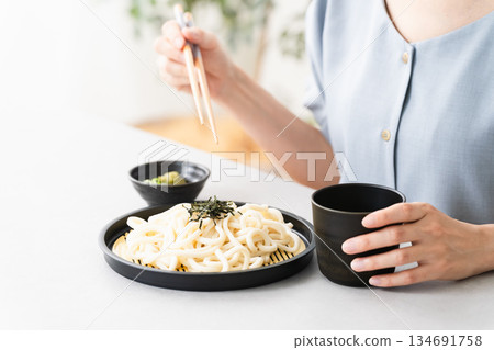 Woman eating udon noodles lifestyle image Woman eating udon noodles lifestyle image 134691758