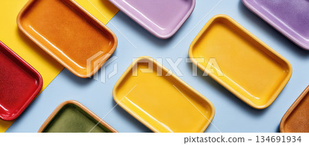 Colorful ceramic tray arrangement sustainable packaging concept with empty trays on pastel background evoking cheerful eco conscious display 134691934