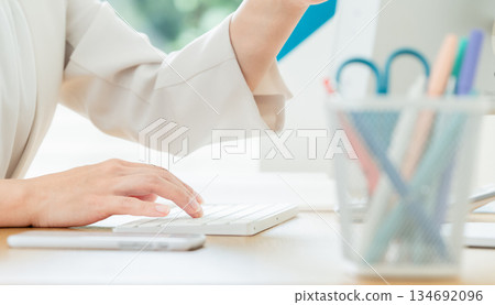 Business woman's hand operating a personal computer Business woman's hand operating a personal computer 134692096