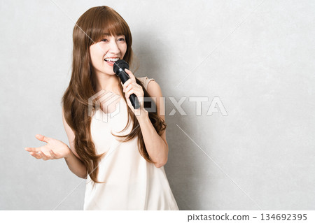 A woman singing with a microphone Lifestyle image 134692395