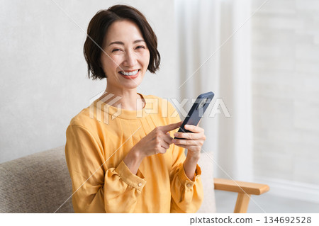 Woman operating a smartphone Lifestyle image 134692528