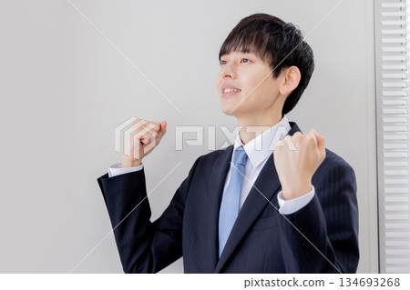 Asian businessman doing a fist pump Asian businessman doing a fist pump 134693268
