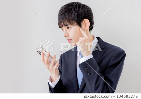 Businessman searching on a smartphone Businessman searching on a smartphone 134693279
