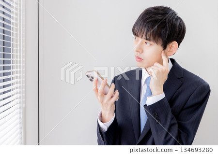 Businessman searching on a smartphone Businessman searching on a smartphone 134693280