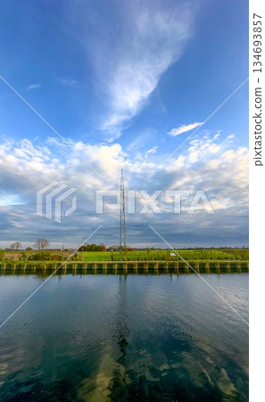A Serene Reflection of a Tall Communication Tower Beautifully Positioned in Nature 134693857
