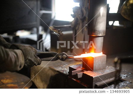 A craftsman who hammers heated materials into shapes 134693905