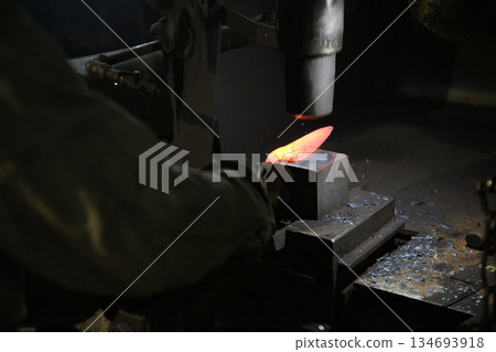 A craftsman who hammers heated materials into shapes 134693918