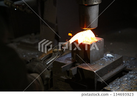 A craftsman who hammers heated materials into shapes 134693923