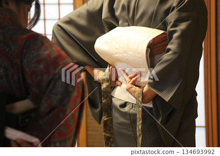 A woman wearing a kimono A woman wearing a kimono 134693992
