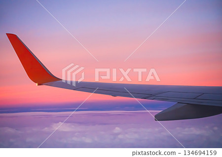 Flight Plane Fly Sky Cloud Sunset View Background, Airplance Wing Aircraft Silhouette Sunrise Gradient Pastel Orange Sunlight, Ket;omer Avoatopm Commercial Transport Tourism Business Corperate Travel. 134694159