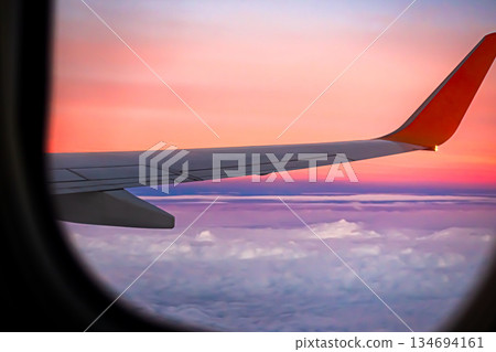Flight Plane Fly Sky Cloud Sunset View Background, Airplance Wing Aircraft Silhouette Sunrise Gradient Pastel Orange Sunlight, Ket;omer Avoatopm Commercial Transport Tourism Business Corperate Travel. Flight Plane Fly Sky Cloud Sunset View Background, Airplance Wing Aircraft Silhouette Sunrise Gradient Pastel Orange Sunlight, Ket;omer Avoatopm Commercial Transport Tourism Business Corperate Travel. 134694161