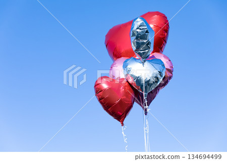 Heart balloon floating in the blue sky 134694499