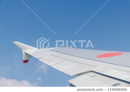 Jet airliner wing and blue sky Jet airliner wing and blue sky 134696066