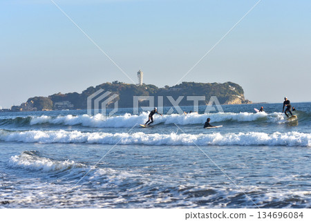 View Enoshima and surfers enjoying the rough waves from Tsujido Beach View Enoshima and surfers enjoying the rough waves from Tsujido Beach 134696084