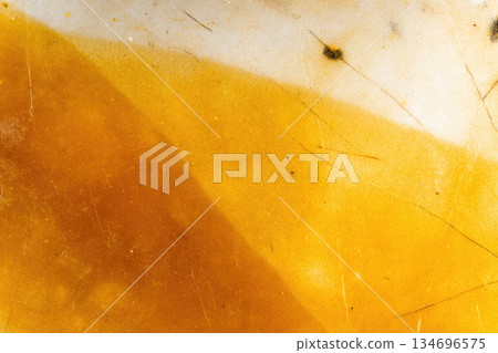 Yellow orange encaustic wax art texture background with abstract pattern, macro photography showing smooth surface, subtle cracks, and organic color gradient, creative and vibrant mood 134696575