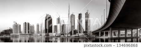 Skyscrapers and bridge over water, black and white style, city background, Dubai Marina bay UAE 134696868