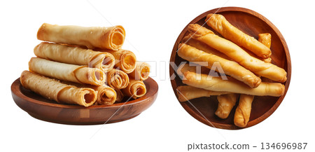 Fried cheese sticks wrapped in dough or spring rolls stacked in pile, isolated on white background, concept of Venezuela snack 134696987