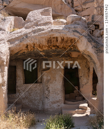 Historic rock-cut cave dwellings in Cappadocia, Nevsehir, Turkey. 134697442