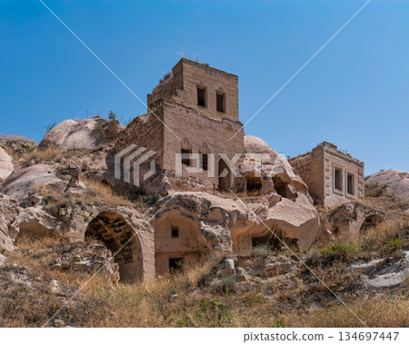 Ancient rock-cut dwellings and historical buildings in Cappadocia, Nevsehir, Turkey. 134697447