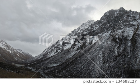 Majestic snow-covered mountains under cloudy sky with dramatic landscape Majestic snow-covered mountains under cloudy sky with dramatic landscape 134698127