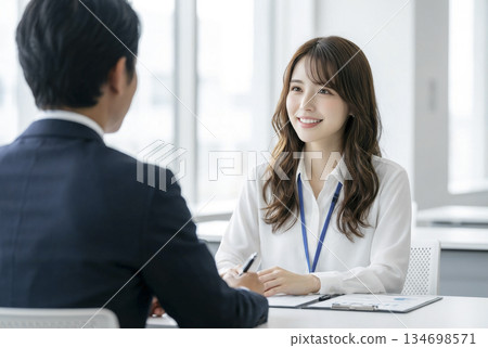 A young woman and a businessman having a meeting 134698571
