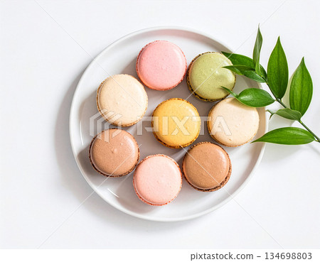 Direct overhead view of colorful macarons arranged on a white plate, minimalist style, pastel colors Direct overhead view of colorful macarons arranged on a white plate, minimalist style, pastel colors 134698803