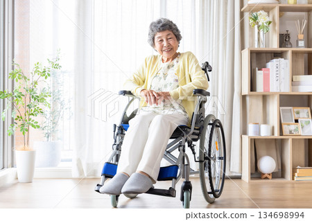 Senior women riding a wheelchair Senior women riding a wheelchair 134698994