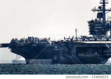 The U.S. Navy nuclear-powered aircraft carrier USS George Washington departs from Yokosuka Naval Base in Kanagawa Prefecture and sails through the Uraga Strait in Tokyo Bay. The U.S. Navy nuclear-powered aircraft carrier USS George Washington departs from Yokosuka Naval Base in Kanagawa Prefecture and sails through the Uraga Strait in Tokyo Bay. 134699223