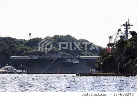 The U.S. Navy nuclear-powered aircraft carrier USS George Washington departs from Yokosuka Naval Base in Kanagawa Prefecture and sails through the Uraga Strait in Tokyo Bay. The U.S. Navy nuclear-powered aircraft carrier USS George Washington departs from Yokosuka Naval Base in Kanagawa Prefecture and sails through the Uraga Strait in Tokyo Bay. 134699248