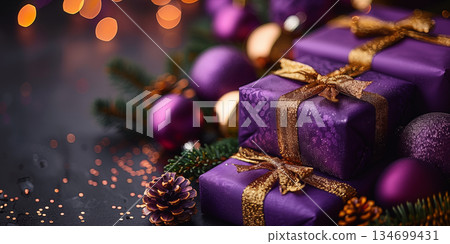 Elegant purple Christmas gifts with golden ribbons surrounded by ornaments and pine branches. Concept of luxury holiday celebration and festive decor. Elegant purple Christmas gifts with golden ribbons surrounded by ornaments and pine branches. Concept of luxury holiday celebration and festive decor. 134699431