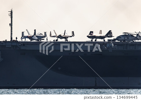 The U.S. Navy nuclear-powered aircraft carrier USS George Washington departs from Yokosuka Naval Base in Kanagawa Prefecture and sails through the Uraga Strait in Tokyo Bay. The U.S. Navy nuclear-powered aircraft carrier USS George Washington departs from Yokosuka Naval Base in Kanagawa Prefecture and sails through the Uraga Strait in Tokyo Bay. 134699445